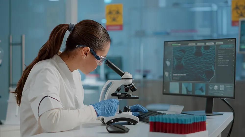 science-engineer-using-microscope-analyze-dna-sample-laboratory-woman-biologist-working-with-microscopic-glass-lens-lab-tool-computer-wearing-protective-goggles-gloveswebp